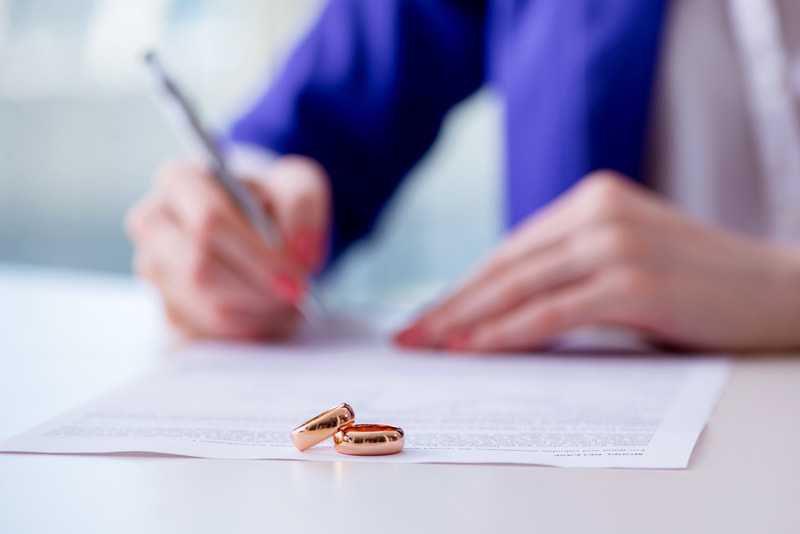 Wedding rings sitting on top of legal forms